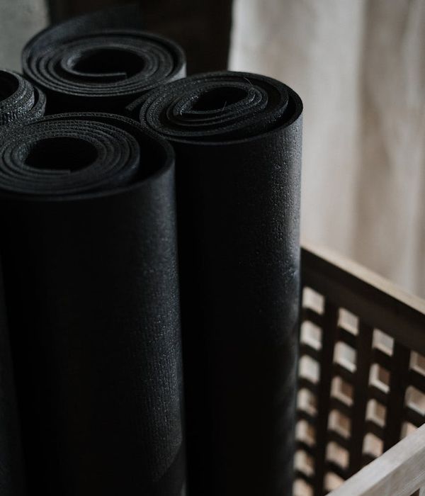 Detailed close-up of yoga equipment on dark wooden floor