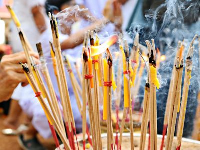 Incense sticks burning in a dark peaceful room